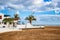 Typical white houses on beach of Playa Honda on Lanzarote island, Spain. Vacation home near sea with palm trees and