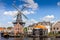 Typical windmill and medieval architecture in the port, Haarlem, The Netherlands