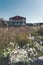 Typical wooden colourful fisher house with iceberg in Disko bay area Greenland and Ilulissat. Typical architecture in