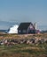 Typical wooden colourful fisher house with iceberg in Qeqertarsuaq, Disko bay area Greenland and Ilulissat. Typical