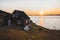 Typical wooden colourful fisher house with iceberg in Qeqertarsuaq, Disko bay area Greenland and Ilulissat. Typical