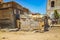 A typical wooden crumbled shack stands on dusty land in the middle of Goree, Seengal. It`s near Dakar, Africa. There`s a mess an