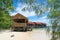 Typical wooden water bungalows on the beach - Waigeo Island, Raja Ampat, West Papua, Indonesia