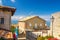 Typical yard with traditional buildings and houses with brick stone walls, flowers, San Marino