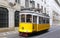 Typical yellow tram on the street of Lisbon