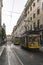 Typical yellow trams in a Lisbon street at dusk