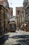 Typical Yellow Vintage Tram in Narrow Street of Lisbon, Portugal.