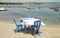 Typically Greek blue restaurant table and chairs beside the sea