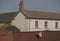 Typically styled English detached cottage seen from the confines of na nearby similar property.