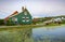 Typically traditional Dutch house, windmill, historical architecture and bridge over water at the Zaanse Schans