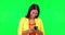 Typing, green screen and happy woman laughing with phone for joke, silly or funny humor in studio. Online, comedy and