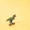 Tyrannosaurus rex on a skateboard. Yellow background. Minimal t rex design