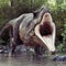 A Tyrannosaurus Rex standing in water with an aggressive stance and a woods background.