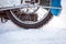 Tyre of motocross bike on ice and snow on background,