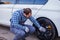 Tyre service worker cheking on a car wheel