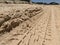 Tyre Tracks In The Sand On The Beach