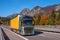 TYROL, AUSTRIA - October 14, 2017: A truck with a yellow van on a high-speed mountain road.
