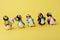 Tyumen, Russia-February 15, 2023: Kinder surprise toy penguins. Collection of kinder surprise toys. Yellow background