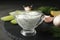 Tzatziki cucumber sauce in glass pitcher with ingredients