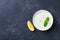 Tzatziki dip sauce or dressing from greek yogurt decorated with lemon and mint. Traditional mediterranean food. Top view.