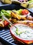 Tzatziki sauce. Tzatziki dressing. Tzatziki dressing with grilled chicken legs and fresh vegetable,lettuce leaf and cherry