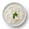 Tzatziki in white ceramic bowl isolated on white from above. Min