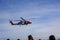 A U.S. Coast Guard helicopter performing a medical evacuation for a cruise ship passenger