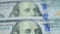 U.S. currency hundred-dollar bills are moving in a blur. Business and Finance