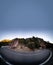 U-shape curved road and tunnel under blue sky