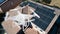 UAV Drone Inspecting Solar Panels On Large House