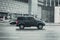 UAZ Patriot rides on the city road. Russian offroad car moves on the wet winter road