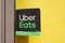 Uber eats sign brand and text logo front door windows of restaurant company shop food