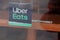 Uber eats sign brand and text logo front of windows of restaurant company shop food