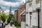 Uccle, Brussels Belgium -Man with a bicycle driving up the curling Saint Job street with a view over the church tower