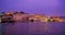 Udaipur City Palace on bank of lake Pichola with tourist boat. Rajasthan. Sunset at Udaipur, India
