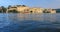 Udaipur City Palace on lake Pichola with tourist boat. Udaipur, Rajasthan, India