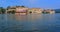 Udaipur City Palace on lake Pichola with tourist boat. Udaipur, Rajasthan, India