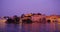 Udaipur Lal ghat, houses and City Palace on bank of lake Pichola at dusk in t at Udaipur, India. Horizontal panning