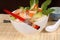 Udon noodles with vegetables and seafood with chopsticks