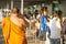 Udon Thani/Thailand-03.02.2017:The tattooed monk walking among the queue of people who are waiting for their turn