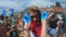 UFA/RUSSIA - 01.07.2019: Many people throwing colorful powder in air together, having fun festival. Youth holding hands