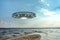 UFO, an alien plate hovering above water, hovering motionless in the air. Unidentified flying object, alien invasion,