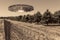 UFO, an alien plate hovering over the field, hovering motionless in the air. Unidentified flying object, alien invasion,