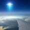 Ufo with bright blue spotlight flies near airplane in dark blue