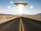 Ufo flying over an empty desert road