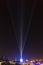 UFO with light rays landing in a city