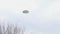 UFO sighting, Flying saucer hovering over houses, metallic reflective aircraft