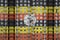 Uganda flag depicted in paint colors on multi-storey residental building under construction. Textured banner on brick wall