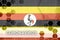 Uganda flag and futuristic digital abstract composition with Coronavirus inscription. Covid-19 outbreak concept