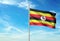 Uganda flag waving with sky on background realistic 3d illustration